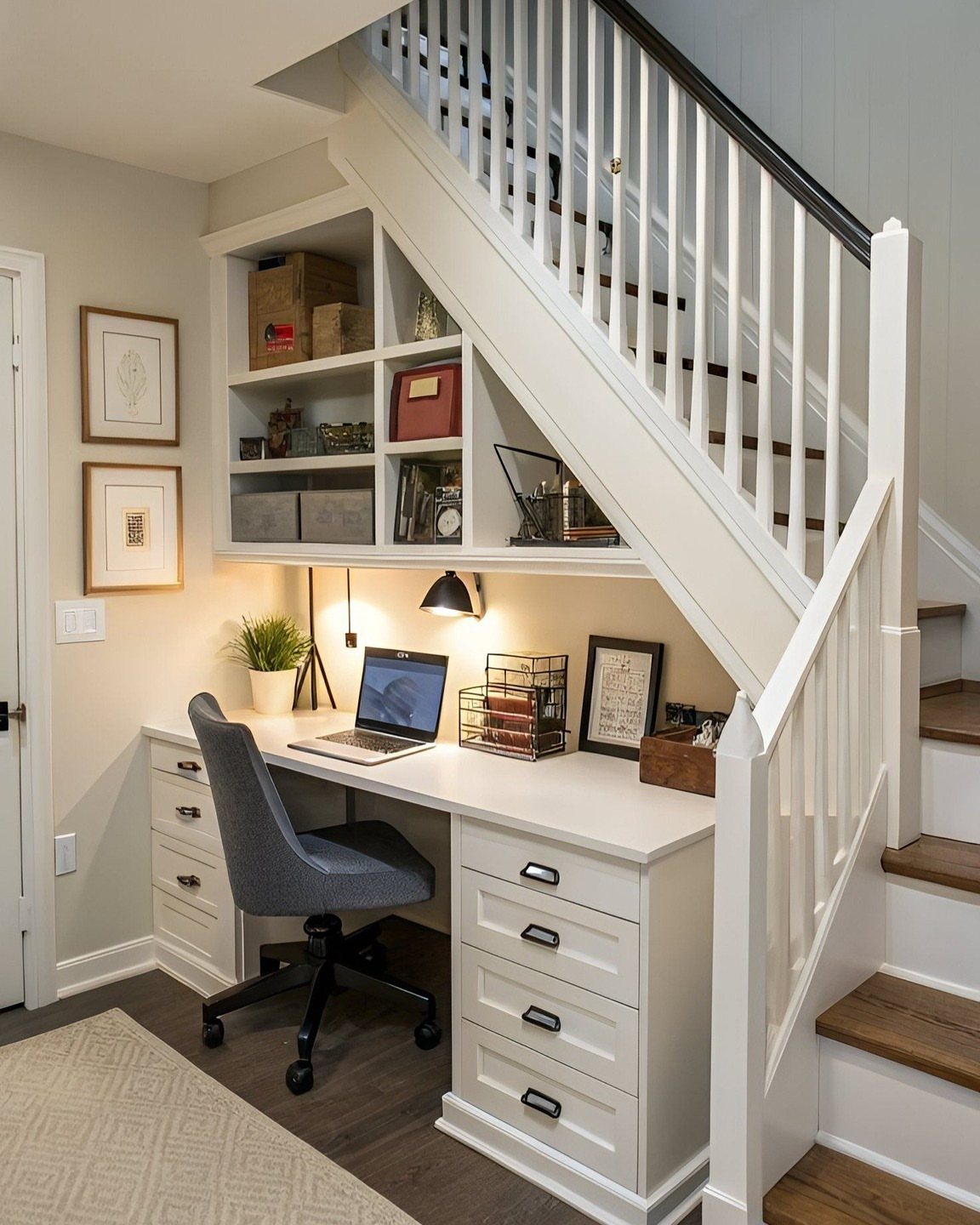 White built-in desk and shelving unit installed in the space under a staircase.