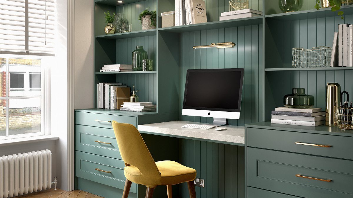 Green built-in alcove office with white desk, yellow chair, and integrated shelving.