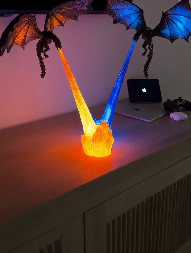 Glowing dragon lamp with orange and blue light on a white desk