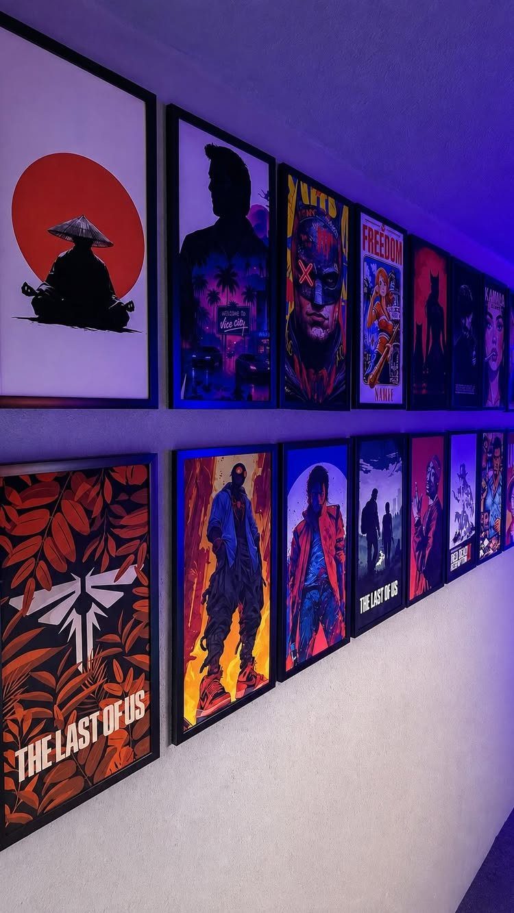 Framed video game posters on a white wall with blue ambient lighting.