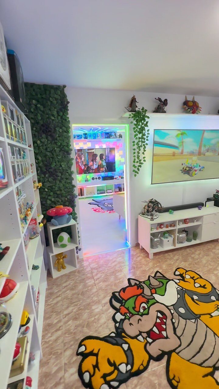 Gaming room with colorful RGB lighting, a Bowser rug, and collectible display shelves.