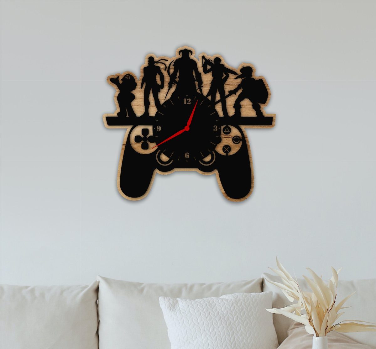 Video game controller wall clock with character silhouettes hanging above a white sofa