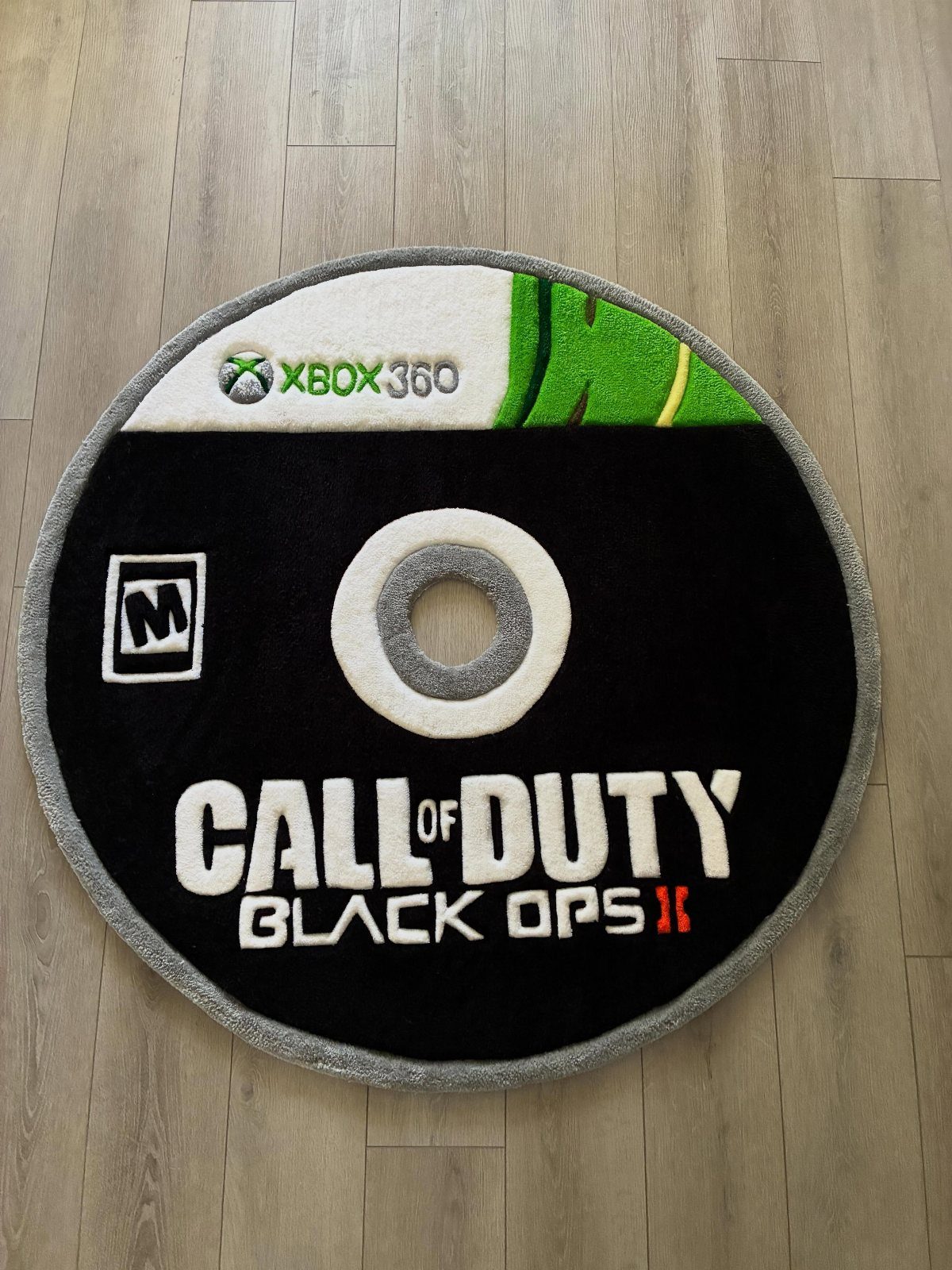 Circular rug shaped like a Call of Duty Black Ops II game disc.