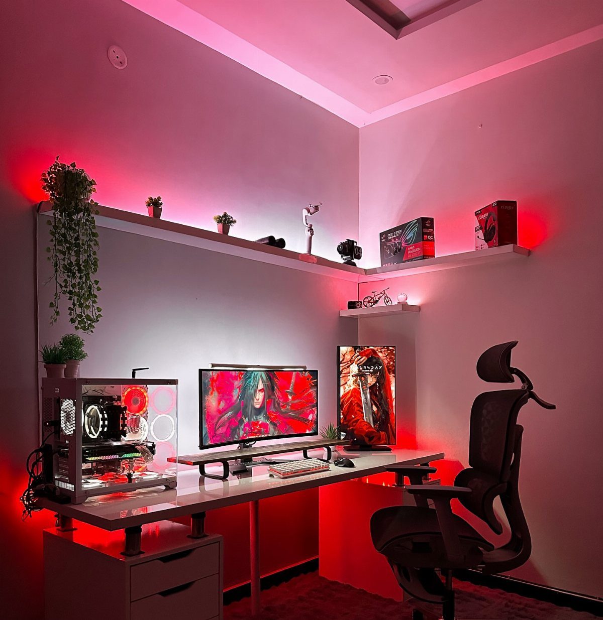 Gaming setup with red ambient lighting, dual monitors, and white floating shelves.
