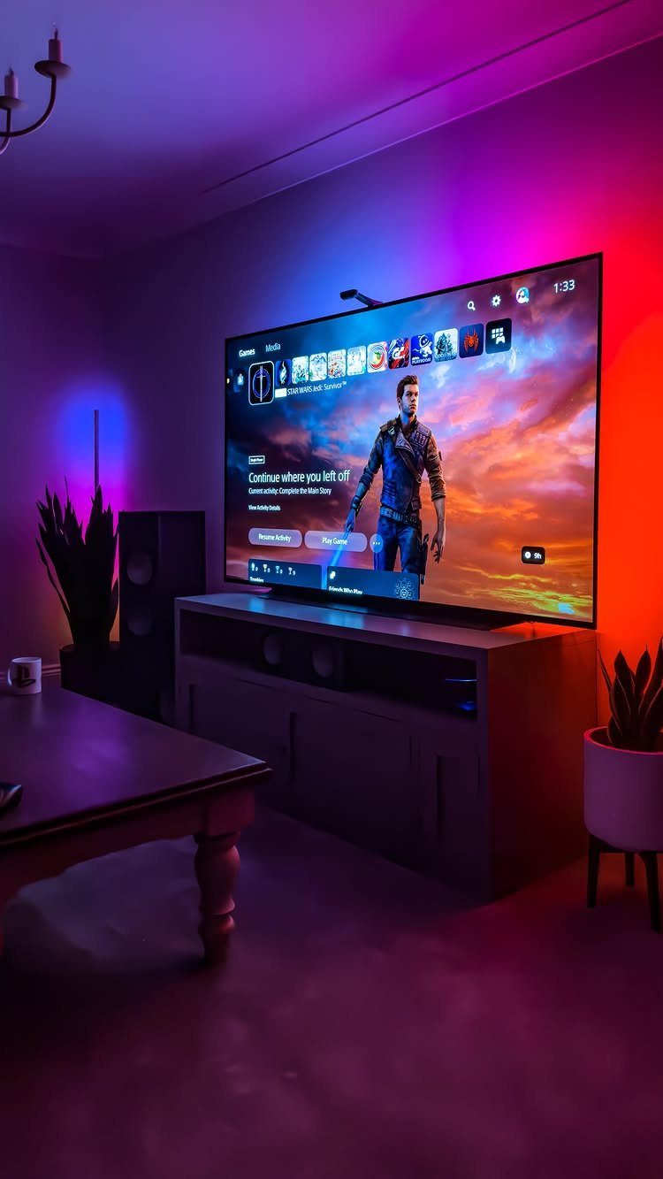 Large television with gaming menu and purple ambient lighting in a modern room