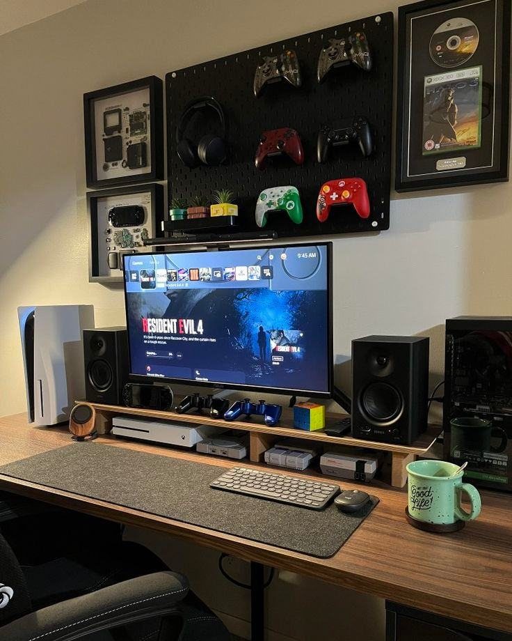 Gaming setup with a wooden desk, large monitor, and pegboard holding controllers.