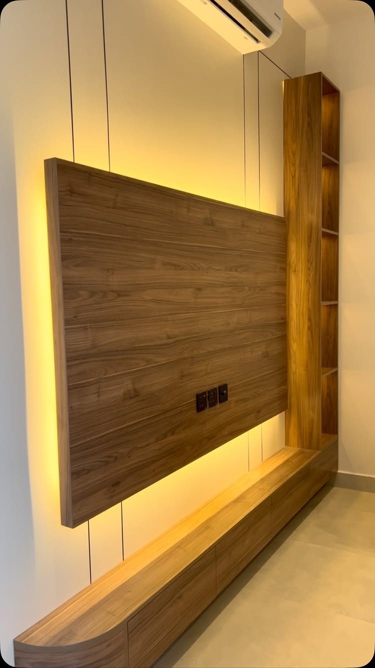 Wooden wall panel with LED backlighting and matching vertical wooden shelves and console.
